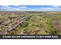 Stunning aerial view of a suburban neighborhood with lush green spaces and walking trails winding through the community at 7829 S Coolidge Way, Aurora, CO 80016