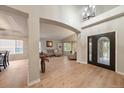 Bright living room with soaring ceilings, hardwood floors, and decorative windows at 7829 S Coolidge Way, Aurora, CO 80016