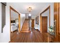 Elegant foyer with hardwood floors, staircase, and decorative accents creating a welcoming entrance at 3811 E 26Th Avenue Pkwy, Denver, CO 80205