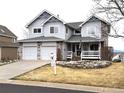 Charming two-story home with a manicured front yard and two-car garage at 227 Powderhorn Trl, Broomfield, CO 80020