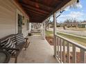 Cozy covered front porch with ample seating and charming string lights creating a warm ambiance at 3244 S Holly St, Denver, CO 80222