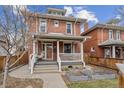 Charming brick home featuring a welcoming front porch and well-maintained landscaping at 1939 W 39Th Ave, Denver, CO 80211