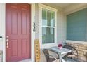 Inviting front porch featuring a welcome sign and cozy seating area at 11330 Pacific Peak Ct, Parker, CO 80134