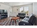 Spacious living room with lots of natural light and cozy black sofas at 11330 Pacific Peak Ct, Parker, CO 80134