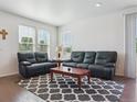 Bright living room featuring comfortable leather sofas and hardwood floors at 11330 Pacific Peak Ct, Parker, CO 80134