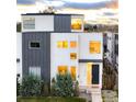 Modern two-story home boasts clean lines and a mix of white stucco and gray metal siding at 2685 S Acoma St, Denver, CO 80223