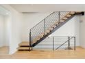 Modern staircase features natural wood treads and an artistic black metal handrail system at 2685 S Acoma St, Denver, CO 80223