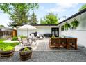 Backyard patio area with seating, plants, and a gravel landscape for outdoor entertaining at 7695 S Sheridan Ct, Littleton, CO 80128