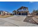 Well-maintained two-story home with stone accents, spacious driveway, and attached two-car garage at 6236 S Robertsdale Ct, Aurora, CO 80016