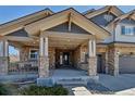 Inviting front porch with stone pillars and a seating area, creating a welcoming entrance at 6236 S Robertsdale Ct, Aurora, CO 80016