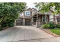 Inviting two-story home featuring a welcoming front porch and three-car garage at 13241 Heart Lake Way, Broomfield, CO 80020