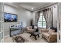 Cozy living room featuring neutral tones, comfortable seating, and ample natural light at 13241 Heart Lake Way, Broomfield, CO 80020