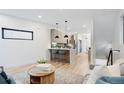 Open-concept living space with modern decor, hardwood floors, and bright, neutral color scheme at 1727 Lowell Blvd, Denver, CO 80204