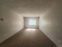 Bedroom featuring neutral carpet, window with blinds and a wall mounted air conditioner at 9650 Huron St # 23, Thornton, CO 80260