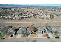 Aerial view of the property showcasing neighborhood, nearby green spaces, and mountain views at 1164 English Sparrow Trl, Highlands Ranch, CO 80129