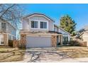 Two-story home with neutral paint, attached garage, and mature trees at 1164 English Sparrow Trl, Highlands Ranch, CO 80129