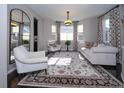 Bright and airy living room featuring elegant curtains, a patterned rug and cozy seating at 14193 Double Dutch Cir, Parker, CO 80134