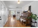 Bright and airy foyer featuring hardwood floors, a staircase, and a vintage piano at 30484 Chisholm Trl, Elizabeth, CO 80107