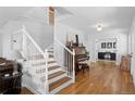 Elegant foyer with a staircase, gleaming hardwood floors, and natural light at 30484 Chisholm Trl, Elizabeth, CO 80107