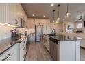 Modern kitchen with white cabinetry, stainless steel appliances, and a large island for cooking at 11560 Dewey St, Parker, CO 80138