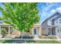 Street view of a two-story home with a blue door and a cozy, covered front porch at 1903 W 66Th Ave, Denver, CO 80221
