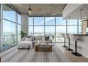 Bright living room featuring floor to ceiling windows with city views and modern furnishings at 1700 Bassett St # 1106, Denver, CO 80202