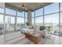 Living room features a concrete ceiling, modern decor, and expansive windows with city views at 1700 Bassett St # 1106, Denver, CO 80202