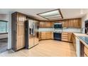 Spacious kitchen featuring wooden cabinets and stainless steel appliances at 9670 W 70Th Ave, Arvada, CO 80004