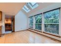 Bright room with skylights and large windows overlooking lush greenery at 9670 W 70Th Ave, Arvada, CO 80004
