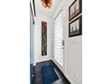 Contemporary entryway featuring stylish light fixture, artwork, and modern front door with privacy screen at 4150 Longview Ln, Boulder, CO 80301