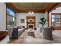 Cozy living room with a decorative fireplace, large windows, and comfortable seating at 1650 N Pennsylvania St, Denver, CO 80203