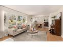 Bright living room featuring stylish furniture, large windows, and an open layout ideal for modern living at 374 Holly St, Denver, CO 80220