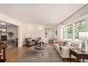 Inviting living room featuring hardwood floors, comfortable seating, and large windows at 374 Holly St, Denver, CO 80220
