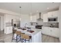Well-lit modern kitchen with stainless steel appliances, granite counters, and island seating at 13708 Daffodil Pt, Parker, CO 80134