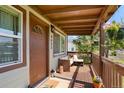 Inviting front porch with seating and hanging plants at 6653 N Knox Ct, Denver, CO 80221