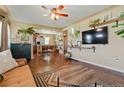 Open living room with hardwood floors and a view of the kitchen at 6653 N Knox Ct, Denver, CO 80221