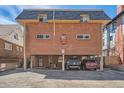 Brick building exterior with parking and a spacious yard at 1355 Gaylord St # 10, Denver, CO 80206