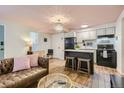 Open kitchen with island, granite countertops, and modern appliances at 1355 Gaylord St # 10, Denver, CO 80206