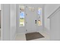 Bright foyer showcases a clean white front door flanked by side windows, creating an airy entrance at 11000 Shining Star Cir, Parker, CO 80134