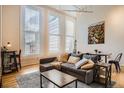 Comfortable living room featuring large windows, hardwood floors, and stylish furnishings at 1555 California St # 304, Denver, CO 80202