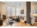 Spacious living room with hardwood floors, exposed duct work, large windows, and modern decor at 1555 California St # 304, Denver, CO 80202