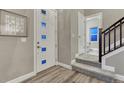 Bright foyer with modern front door and staircase leading to the upper level at 1734 Peak Prairie Ln, Monument, CO 80132