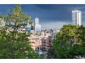 Scenic city view featuring modern architecture, visible through lush green trees at 3069 Tejon St # B, Denver, CO 80211