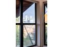 A window frames a view of the city skyline, showcasing modern architecture and urban landscapes at 3069 Tejon St # B, Denver, CO 80211