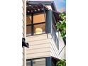 Architectural detail of exterior window with sunshades, revealing a modern lamp inside at 3069 Tejon St # B, Denver, CO 80211