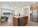Kitchen with stainless steel refrigerator, granite counters, and stainless steel dishwasher at 6153 N Ceylon St # 203, Denver, CO 80249