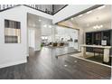 Bright foyer with dark wood floors, glass-enclosed office, and an open floor plan leading to the living and dining areas at 5566 Hickory Oaks Trl, Castle Rock, CO 80104