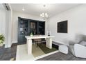 Stylish office featuring a custom built-in bookshelf, modern desk, chair and ottoman with a patterned rug at 5566 Hickory Oaks Trl, Castle Rock, CO 80104