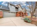 Spacious two-car garage and driveway with landscaped front yard showcasing this lovely home at 84 Inca St, Denver, CO 80223