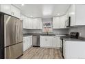 Modern kitchen featuring stainless steel appliances and white cabinetry at 639 Quartz Way, Broomfield, CO 80020